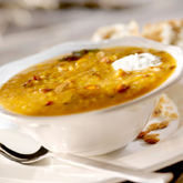 2 Butternut Squash, 3 Tbsp Olive Oil, 1 large onion, finely diced, 1 Tsp coriander seeds, freshly ground, 1/8 tsp red chili flakes, 1 bunch fresh sage, stems removed, finely chopped, 1-2 L organic or homemade vegetable or chicken stock, kosher salt & fresh...